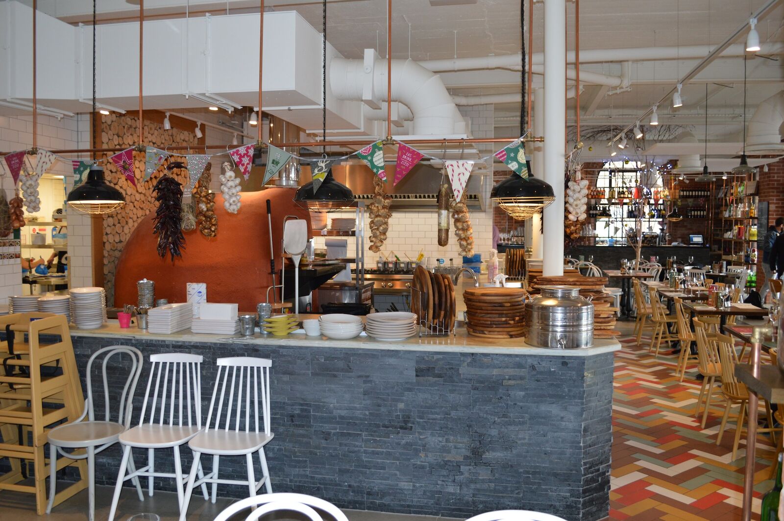 Zizzi Dorchester restaurant fit-out — brand interior with bar and kitchen in market-town building