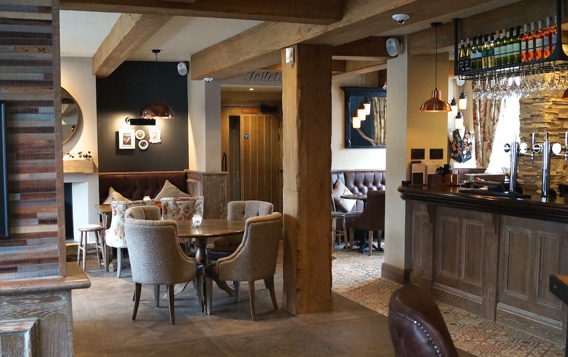 The Waggon Uppermill — pub dining area with warm finishes and bespoke joinery